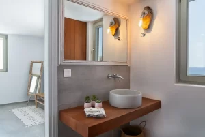 Beautiful wooden bench with the bathroom sink sitting in it.