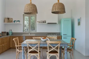 The kitchen and the dinning area inside the house. Greek island simplicity and colours. Using SMEG appliances
