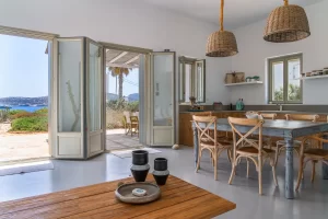 The living room space, the balcony windows the dinning table.