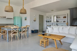 The living room, the main entrance, the dinning table and part of the kitchen